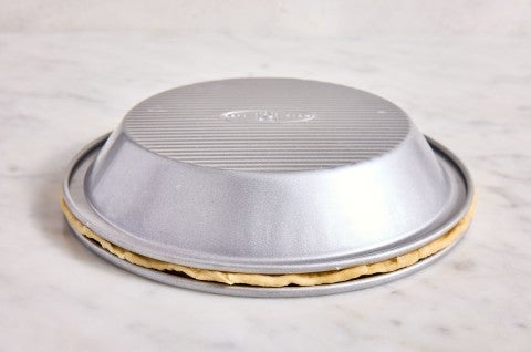 pie crust baked upside down with another pie pan on top