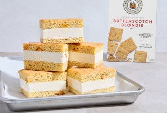 Butterscotch Blondie Ice Cream Sandwiches stacked high on a sheet pan
