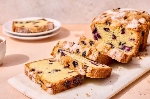 Blueberry Bread sliced on a cutting board - select to zoom