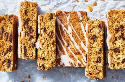 Oatmeal Raisin Cookie Bars sliced up on parchment paper - select to zoom