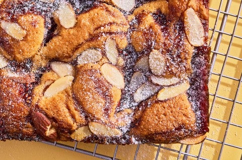 Raspberry Frangipane Bars on a cooling rack unsliced - select to zoom
