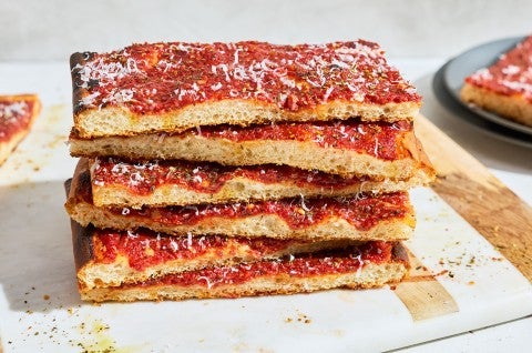 Side photo of a stack of Rhode Island Pizza Strip slices. - select to zoom