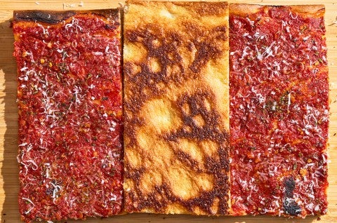 Top down photograph of Rhode Island Pizza Strip showing the middle slice bottom up with golden brown baked tones. - select to zoom
