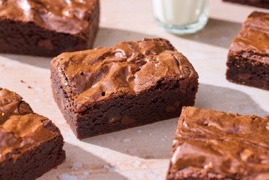 Small-Batch Brownies on a table with a glass of milk