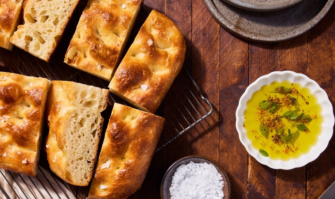 Sourdough Focaccia on a cooling rack with olive oil and salt