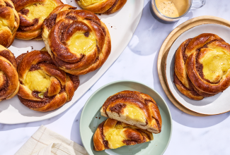 Sunshine buns on plates and arranged on a counter, seen from above.